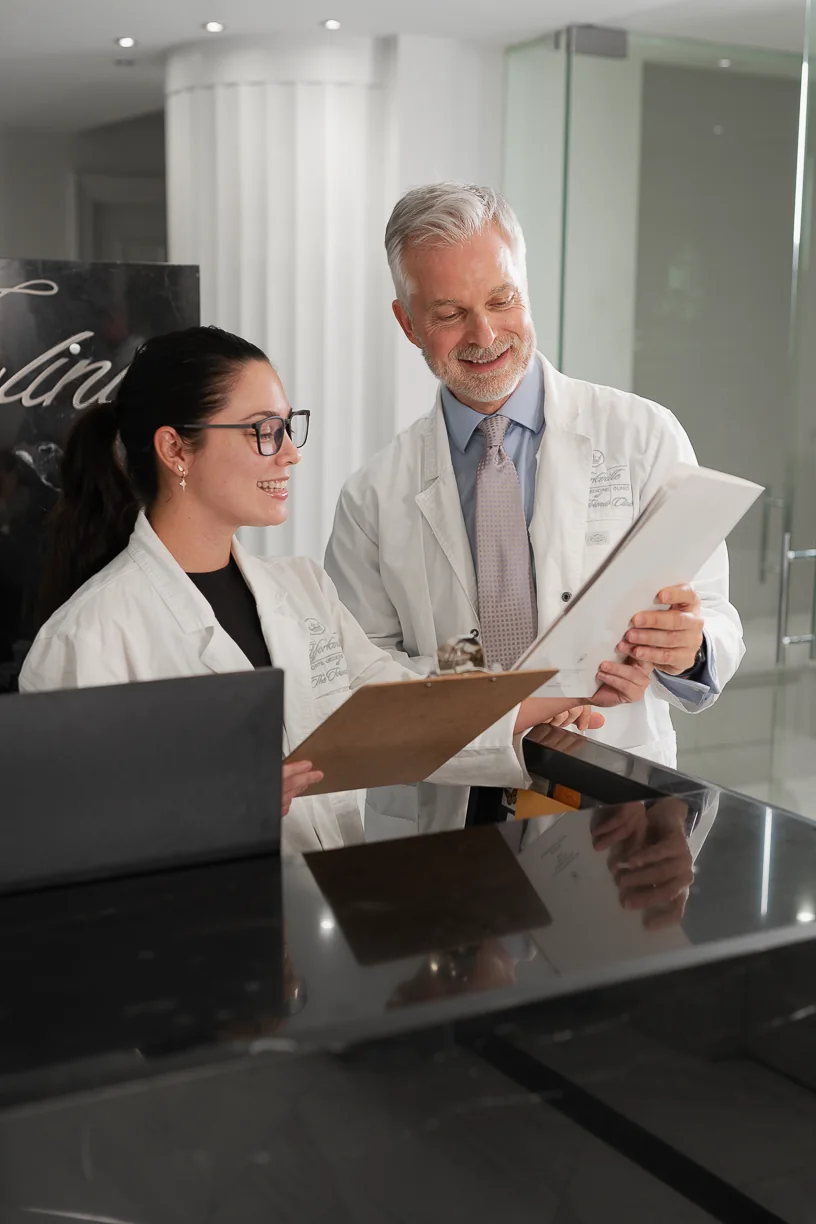 A Yorkville Sports Medicine physician reviewing a chart at reception
